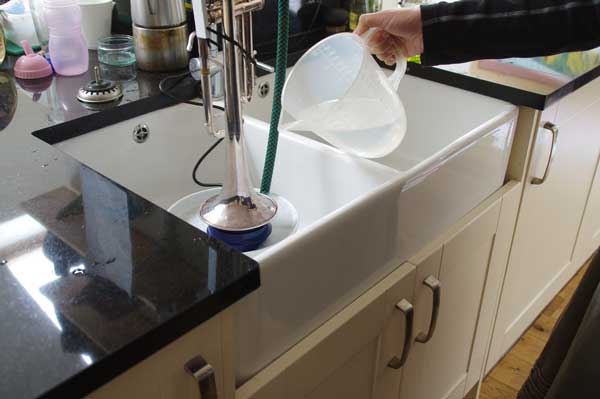 Flushmute - The revolutionary trumpet cleaning system from Spencer Trumpets. Topping up correctly secured Flushmute with additional Spencer Trumpets bore cleaner solution during monthly clean.